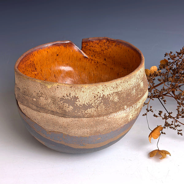 Ceramic bowl with a textured surface on a white background